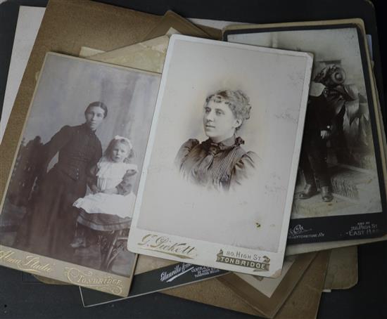 A photograph album, loose photos and a postcard album